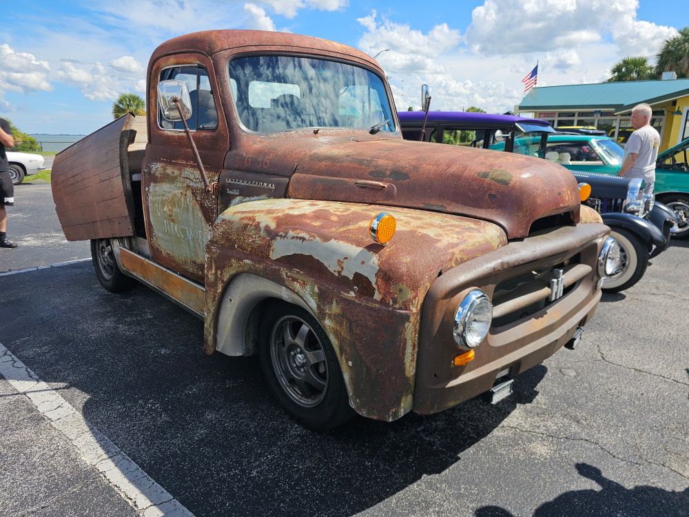 A Prius chassis with a 1940's International Harvester truck body on it.