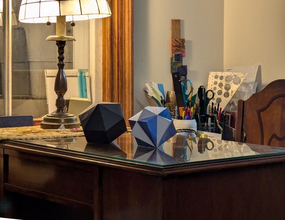 Geometric shapes on a desk. Compound of two cubes and its convex hull.