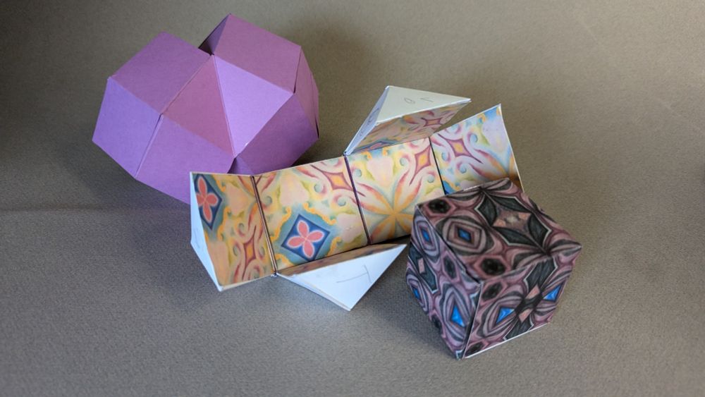 Geometric shapes that nest together. A cube, a rhombic dodecahedron, and a 12 sided box