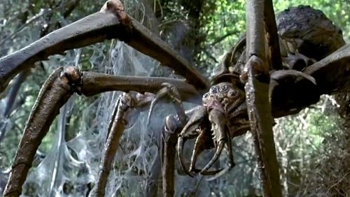 Screenshot of the giant alien spider being shot at in Arachnid (2001).