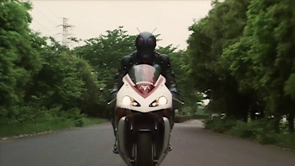 a person riding a motorcycle with the word honda on the front