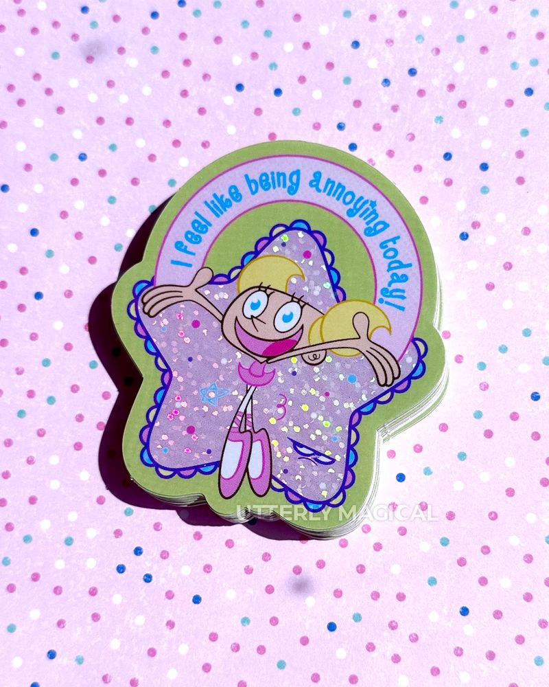 A stack of stickers on a pink polka dot background. 