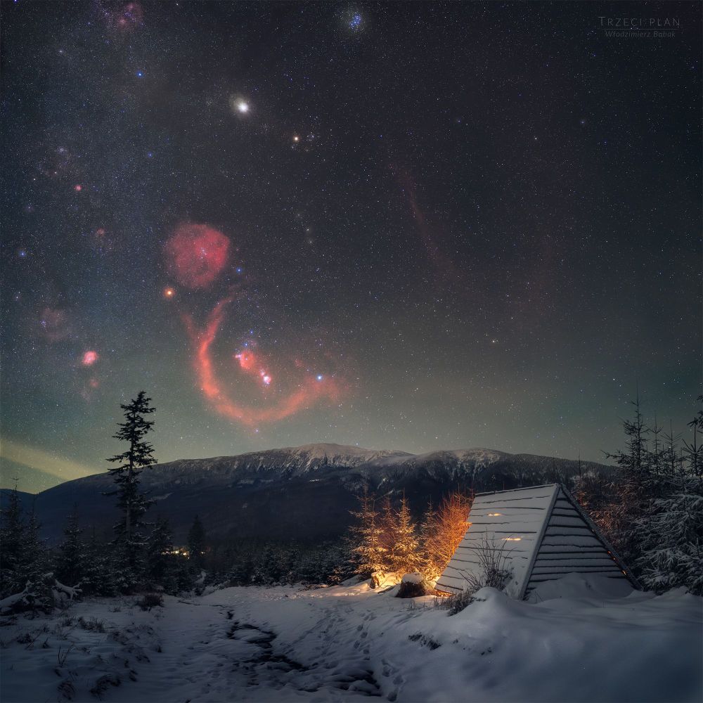 This wintry scene was captured from southern Poland on the northern hemisphere's long solstice night. Otherwise unseen nebulae hang in the sky, revealed by the camera modified to record red hydrogen-alpha light. The nebulae lie near the edge of the Orion molecular cloud and join the Hunter's familiar belt stars and bright giants Betelgeuse and Rigel. Eye of Taurus the Bull, yellowish Aldebaran anchors the V-shaped Hyades star cluster near top center. Still, near opposition in planet Earth's sky, the Solar System's ruling gas giant Jupiter is the brightest celestial beacon above this horizon's snowy peaks.

