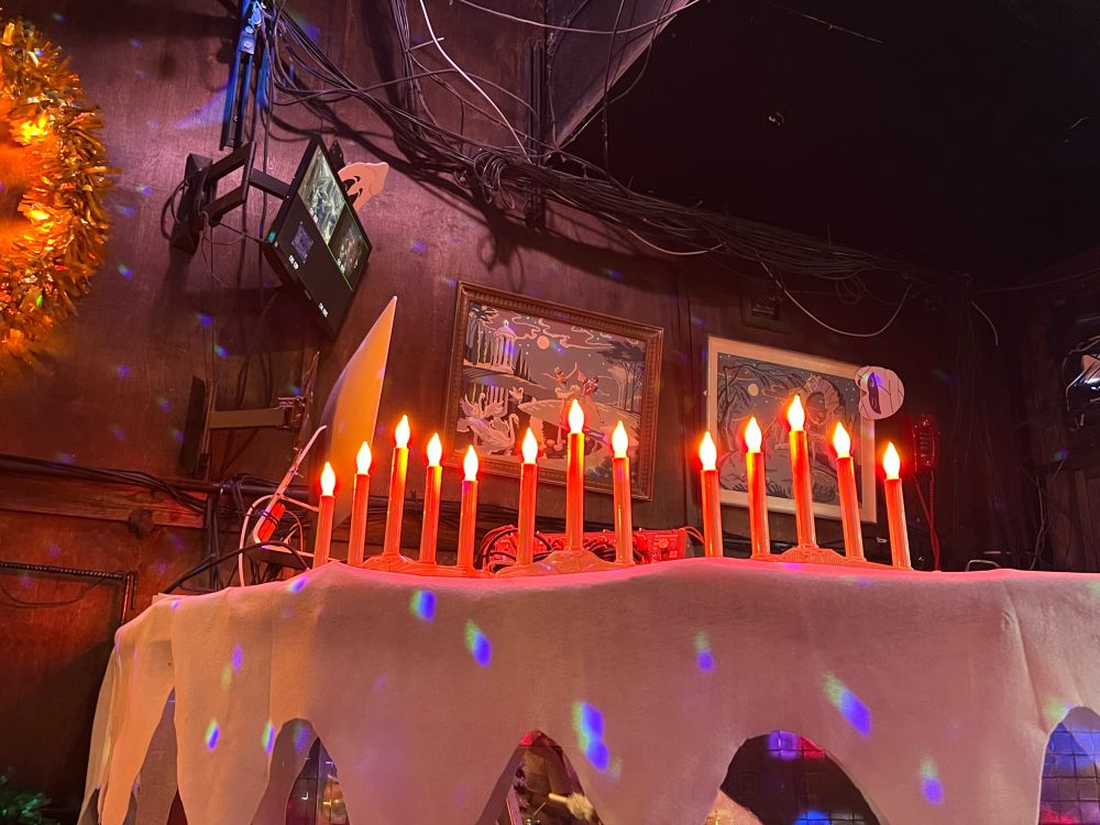 Photo of 13 led candles atop the DJ booth at Mary’s 