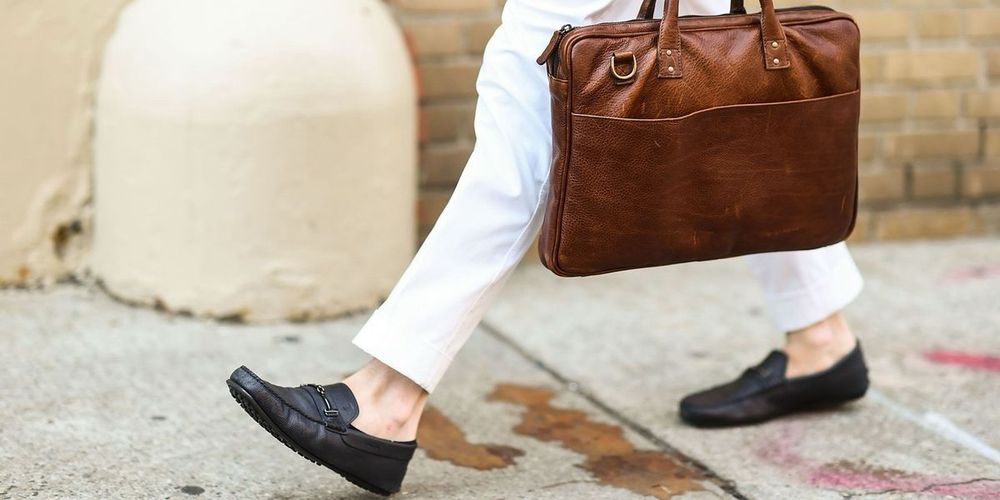Man wearing dress shoes WITHOUT socks, for sweaty, uncomfortable reasons unknown. As displeasing as it is to look at as it presumably to wear…