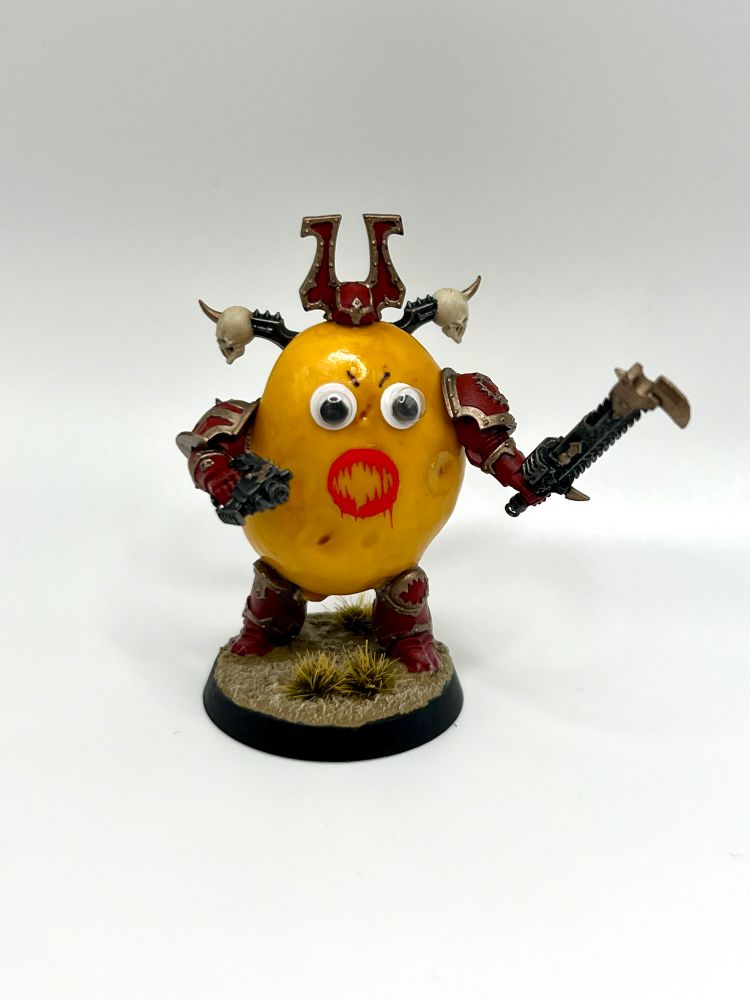A fairly standard paint scheme khorne berserker, but his entire body is a potato with googly eyes on it. 