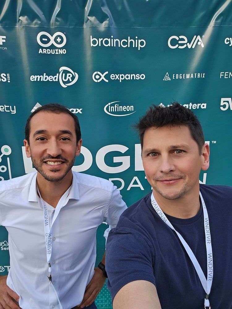 Samir Bounab and I in front of a banner with logos of the EDGE AI FOUNDATION event
