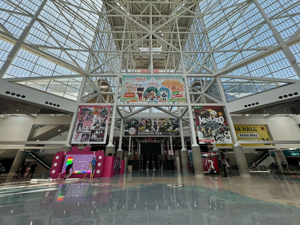An indoor view of the lobby of the Los Angeles Convention Center's South Hall, decorated with banners of Good Smile Company, Bilibili, Demon Slayer, and others.