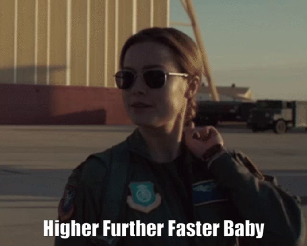 a woman in a military uniform with the words " higher further faster baby " on the bottom