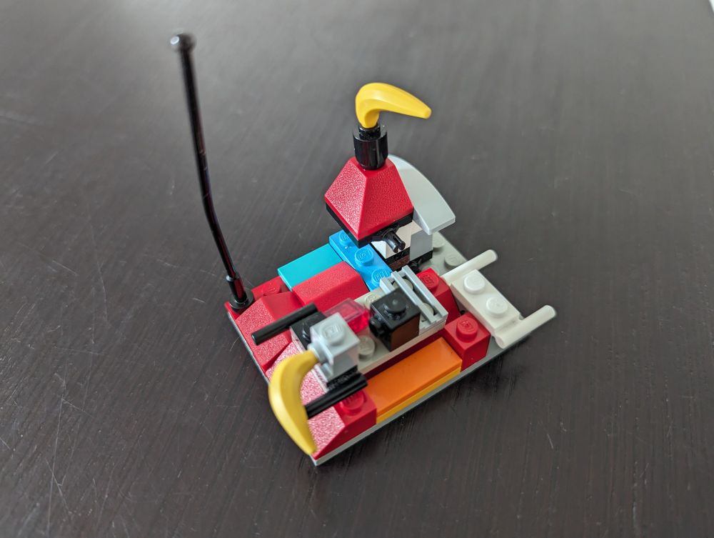 Photo of a Lego contraption with a lego banana sticking out of the top and another banana sticking out at the front.