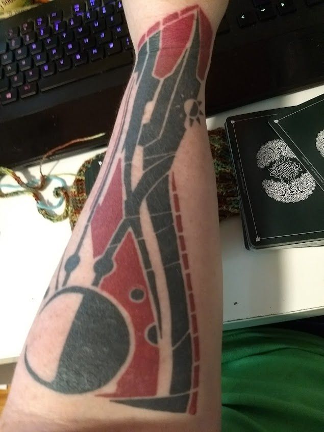 A photo of my left forearm bearing a geometric red and black tattoo, the same tattoo that the protagonist of Titanfall 2 has.