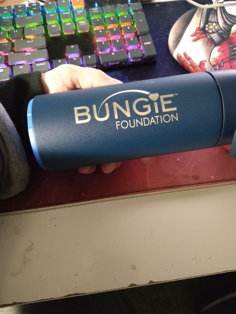 A photo of a water bottle with the words Bungie Foundation printed on it in silver 