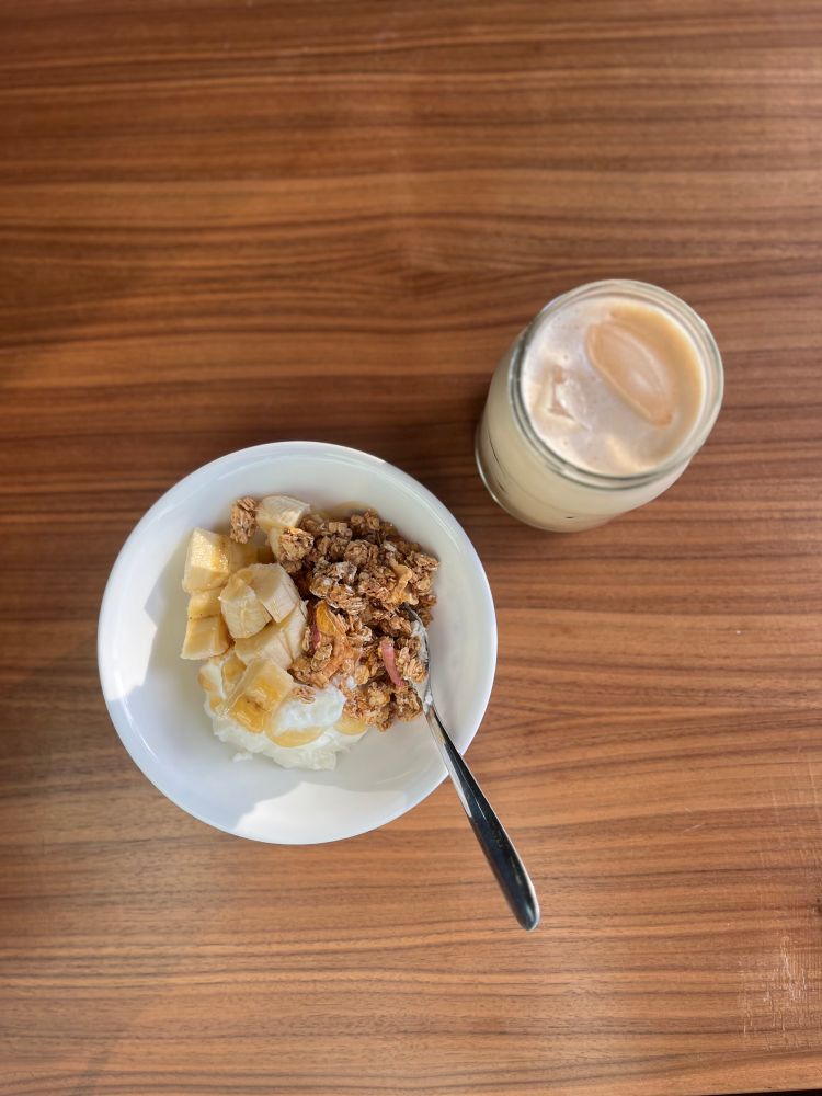Parfait bowl and iced coffee on wood table. 