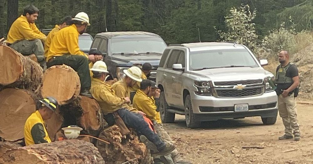 Federal agents showed up northeast of Lake Cushman to check identification of crew members fighting Washington's largest active wildfire.