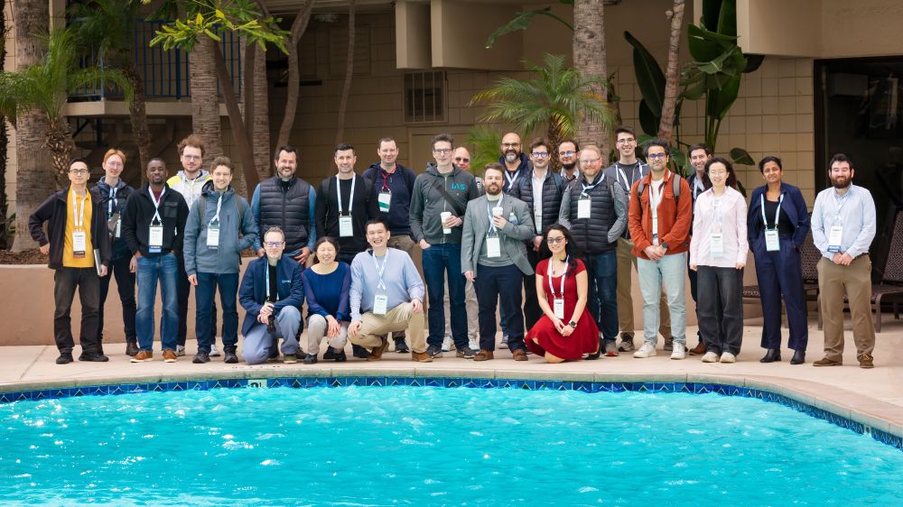 Group picture of MADWeb participants in front of a pool