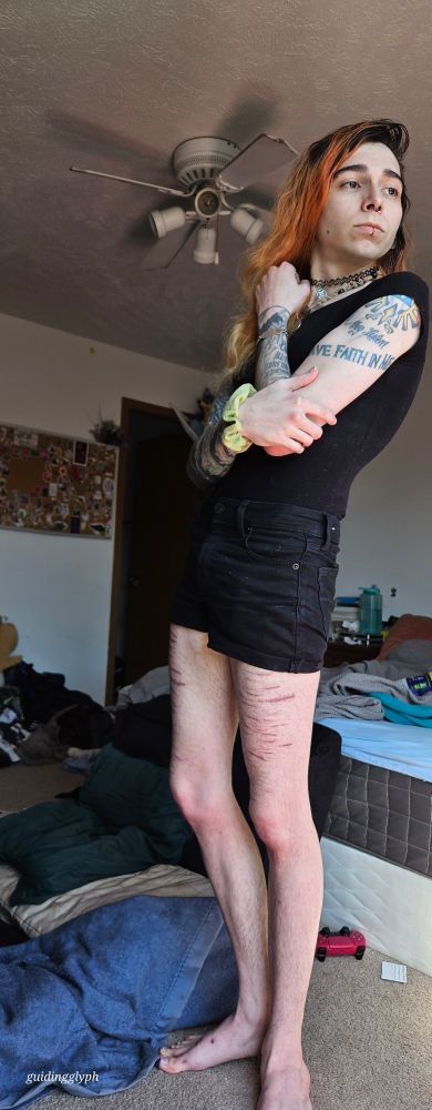 Creature posing with its arm across it's chest looking into the distance