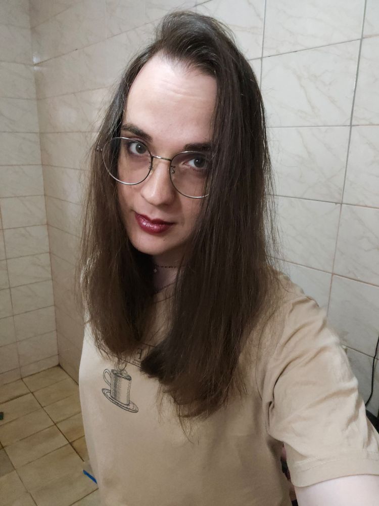 Selfie of Luna. She's wearing bold lipstick and is smiling slightly.