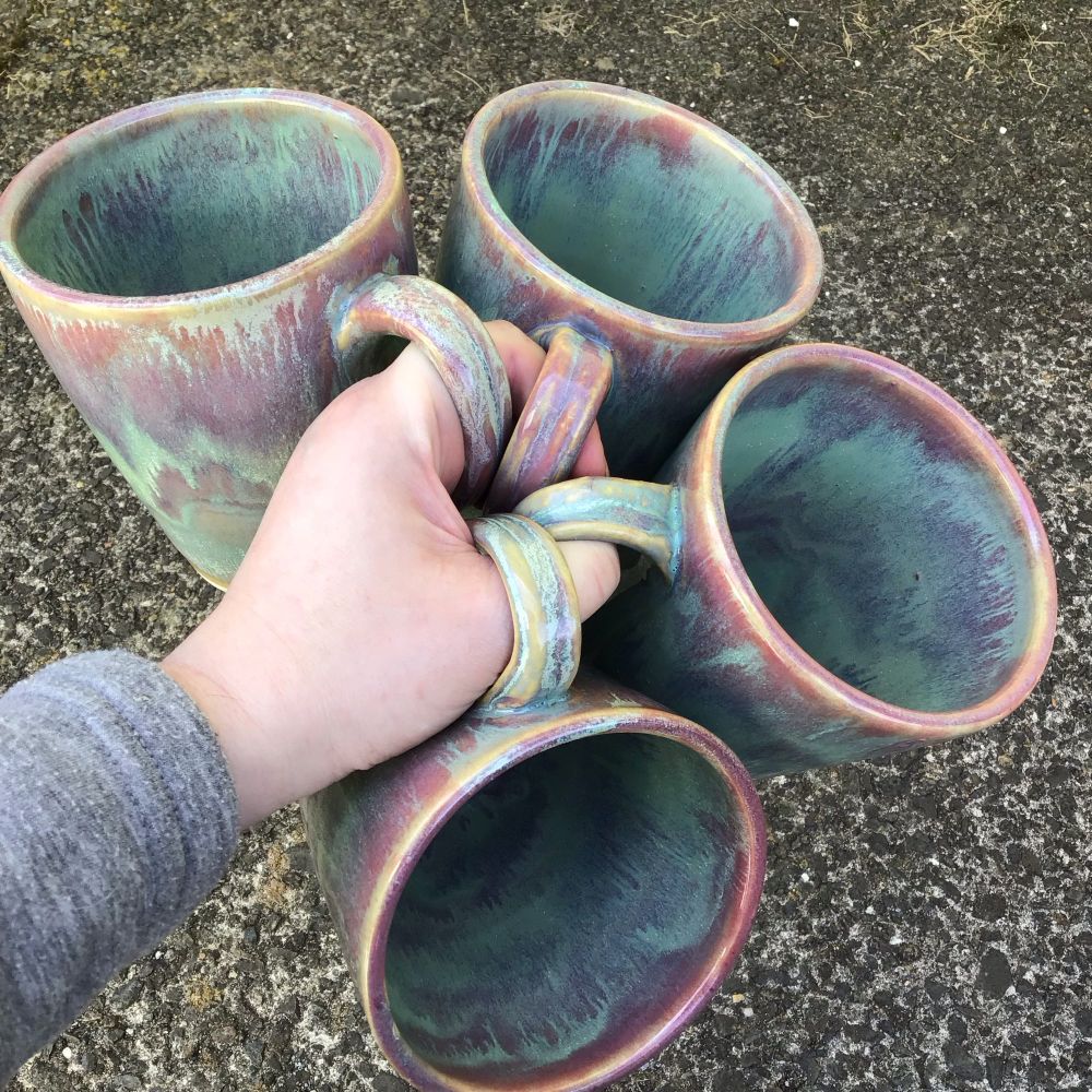 Holding 4 coffee mugs in one hand