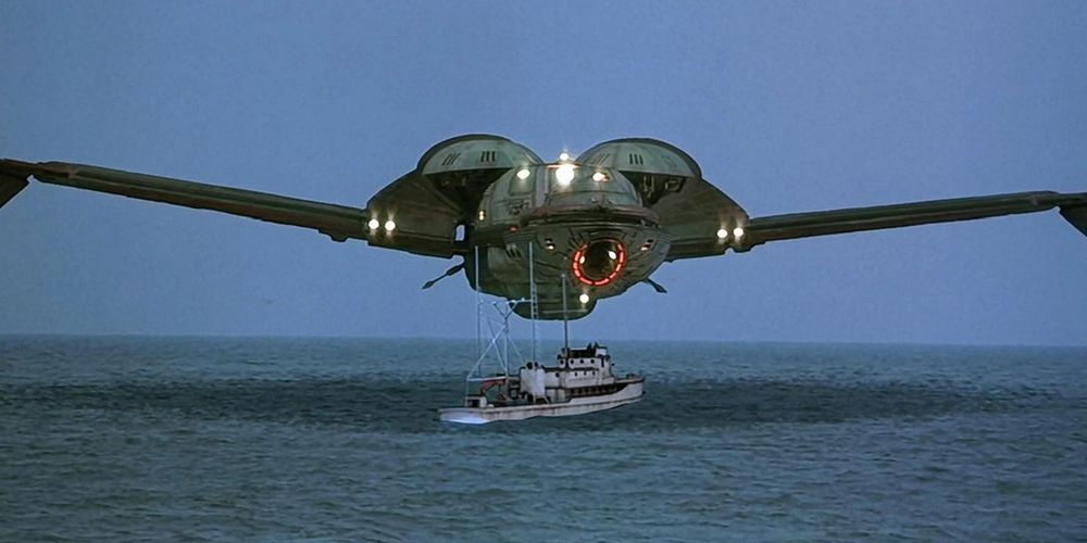 The HMS Bounty, a B'rel-class Klingon Bird-of-Prey, hangs in the air just above the port  bow (scrape 'em off Jim!) of a whaling vessel. Not the best shot, really, since the wings are edge on, missing out the stylized feathers and the long neck of the bridge.