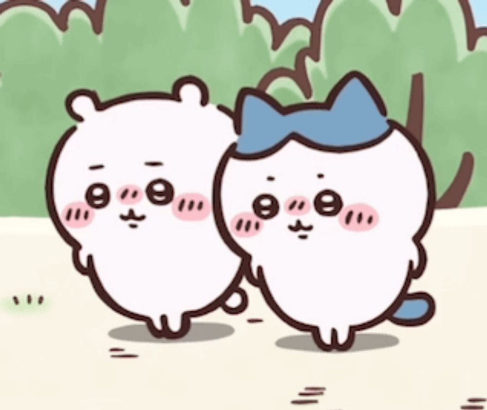 two cartoon cats are standing next to each other on a grassy field .