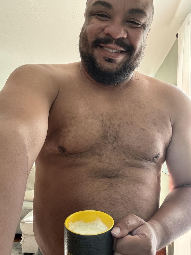 Selfie of me, shirtless, holding a caffeinated beverage