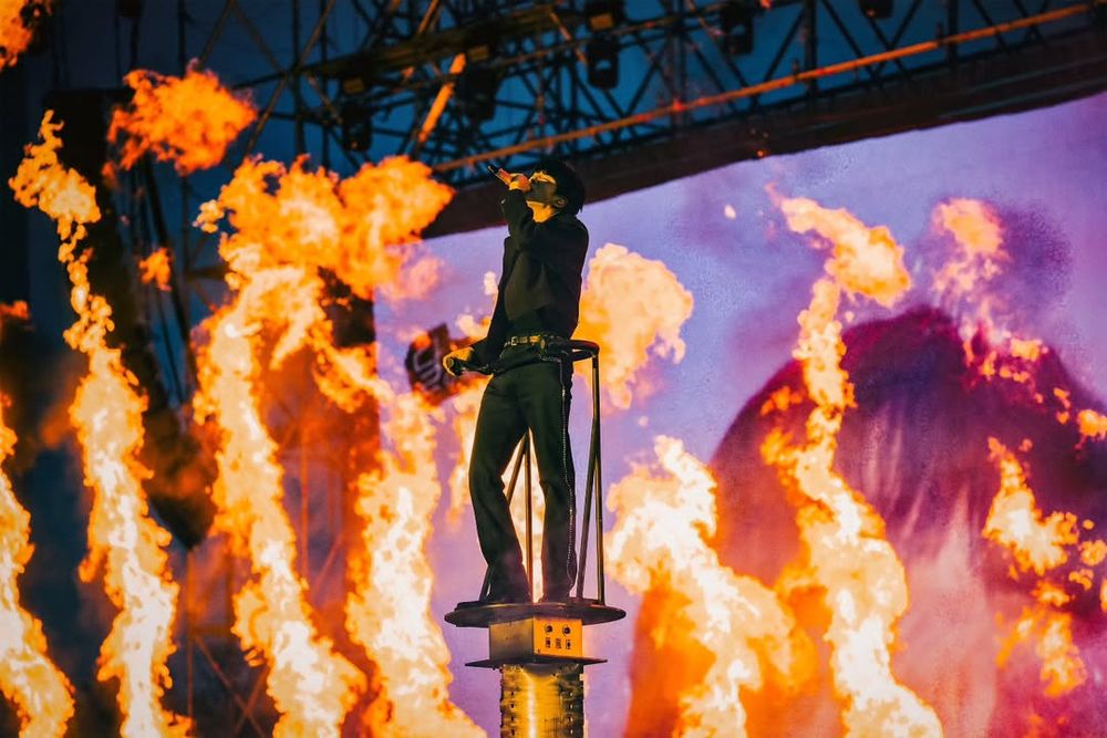 Seokjin towering over ARMY, surrounded by flames, while singing Another Level at his Goyang concert Day 1.