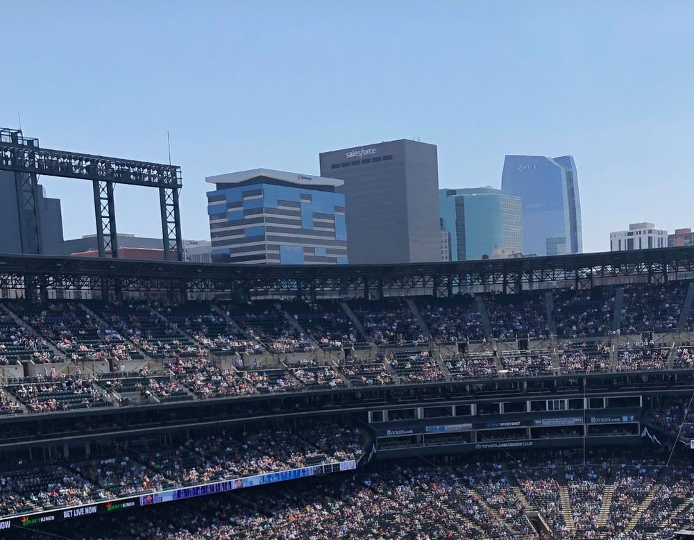 Salesforce Tower looms over Coors Field in Denver, CO.