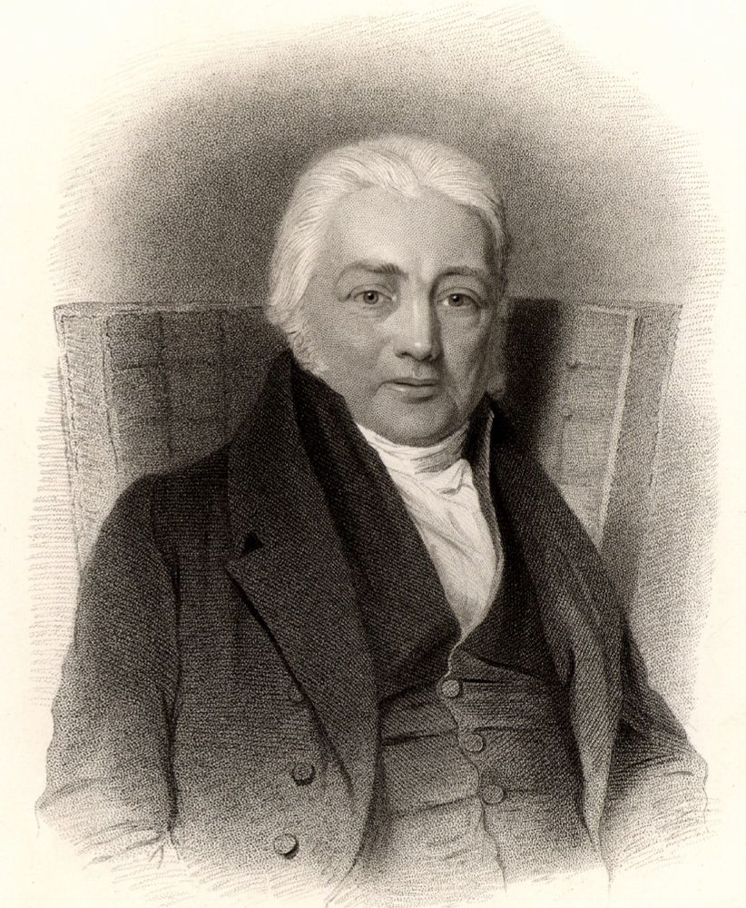 Engraved portrait of Samuel Taylor Coleridge, 19th-century English poet and philosopher, seated and wearing formal attire with a high-collared shirt and dark coat, looking directly at the viewer.