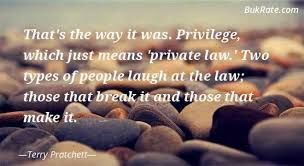 a close up photo of smooth rocks with a Terry Pratchett quote from "Night Watch" superimposed: "That's the was it was. Privilege, which just means 'private law.' Two types of people laugh at the law; those that break it and those that make it."