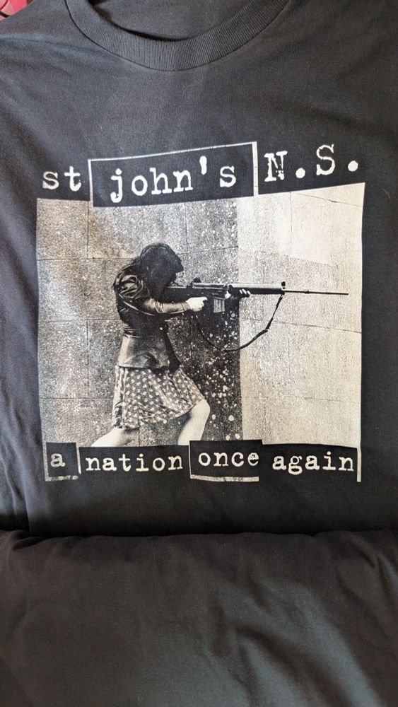 Rage Against The Machine-style shirt featuring a terrorist with a rifle, with the name of my old primary school