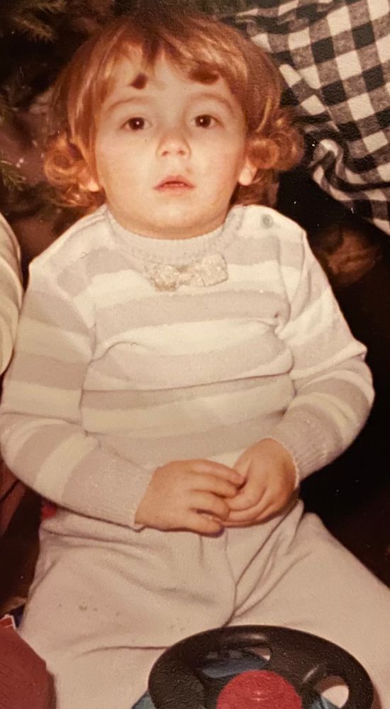 chubby drowsy little boy sitting on his new toy truck
