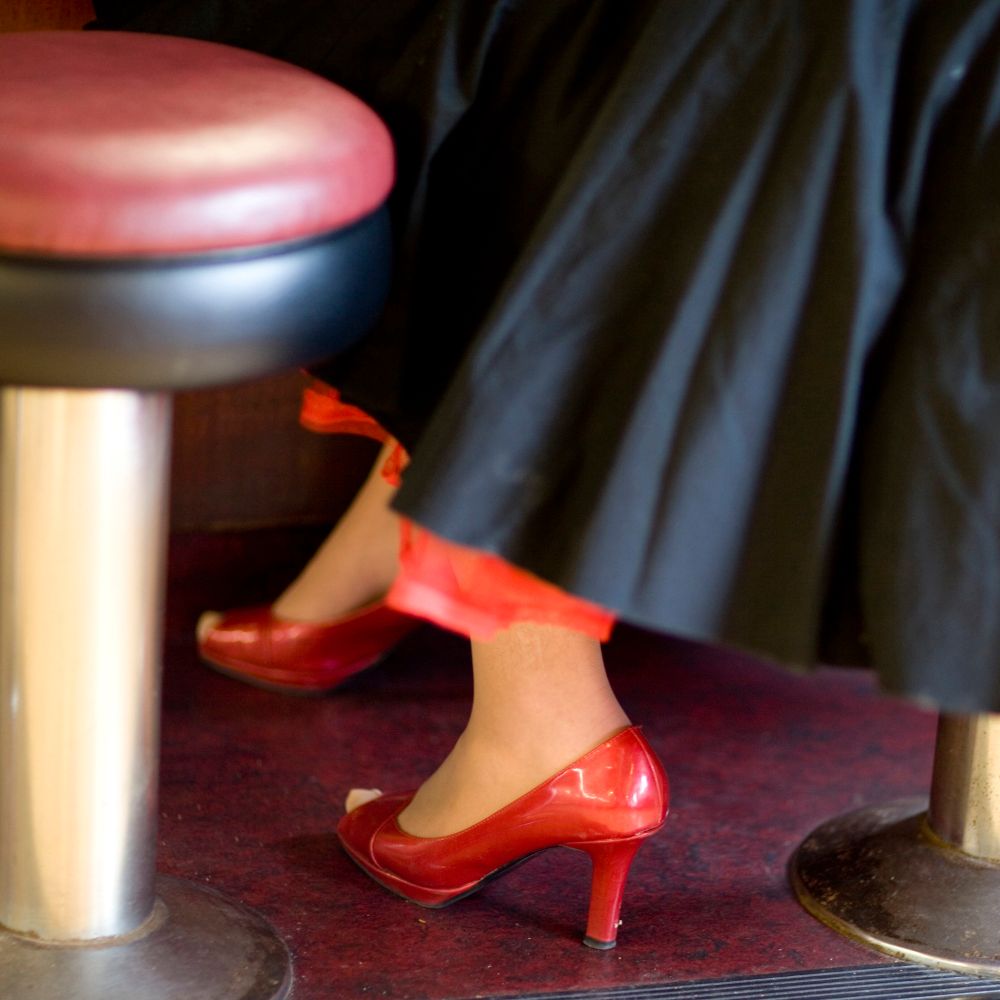 Bar room floor, red high heels. 