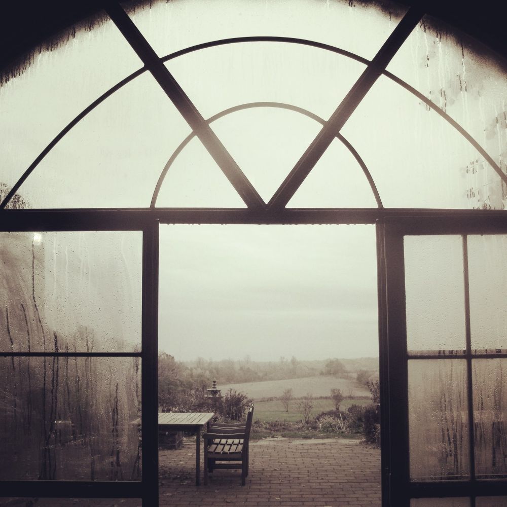 Another gloomy shot, looking through a glass garden arch, with rain streaked windows, onto spring fields . I think all the gloom I'm posting and feeling lately, is partly the state of the world and partly because spring is still eluding us here on the Lake Huron shoreline. Got hit with whiteout blizzards last night and this morning. Ugh. 