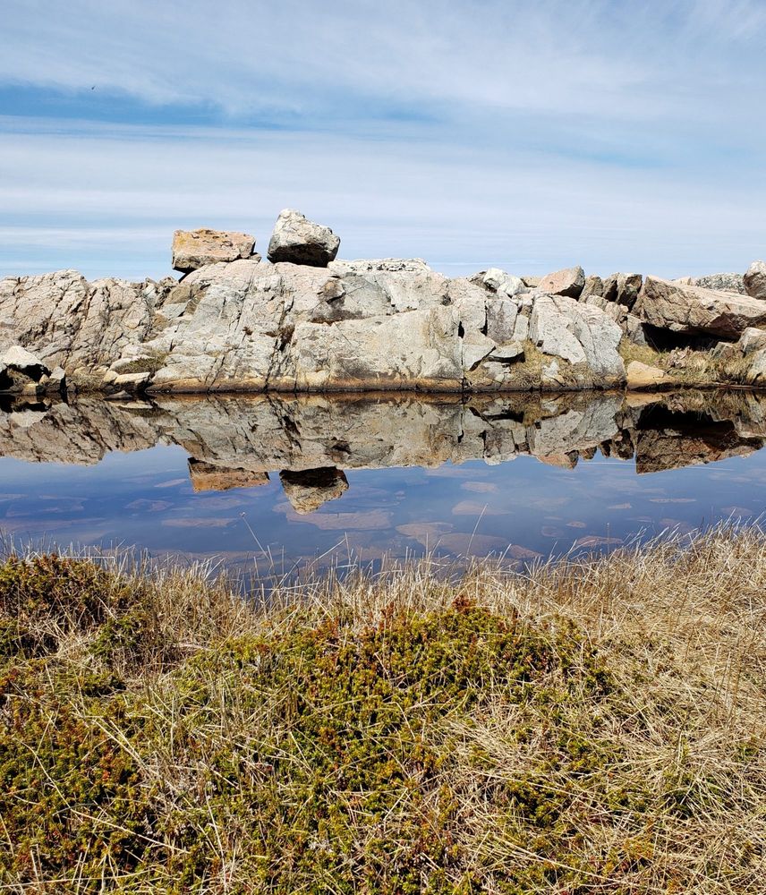 Shoreline of Fogo Island, sky, water, rock. 