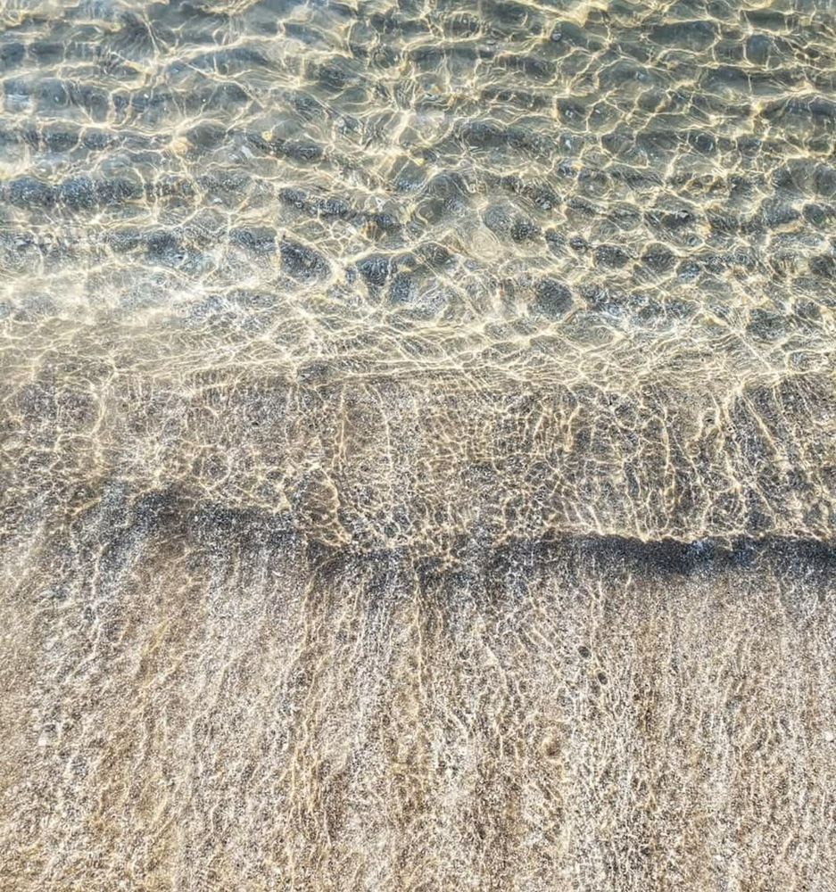 Sensuous interplay of shadows, light, water and sand creates ever changing patterns under the surface of the lake. 