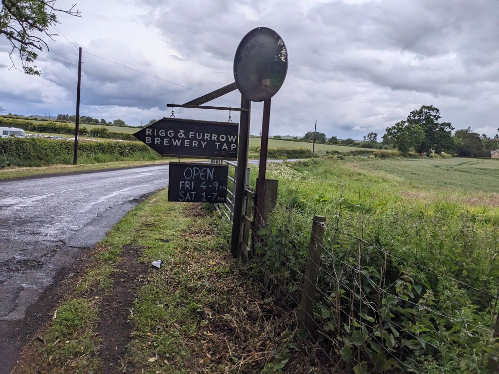 Sign for Rigg and Furrow brewery with opening times