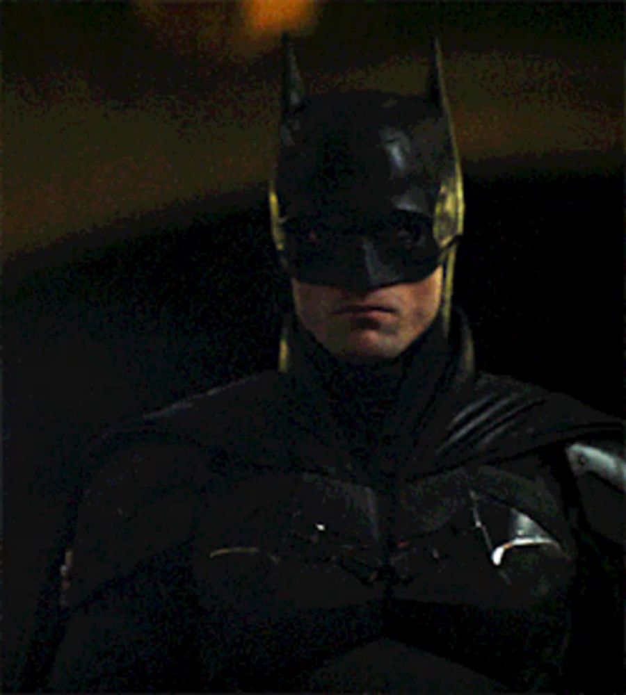 a close up of a man wearing a batman mask