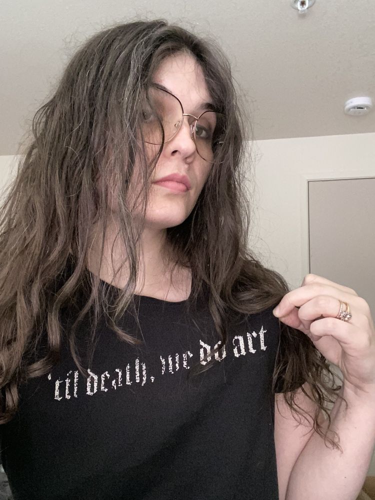A self portrait photograph with the t-shirt reading "'til death, we do art."