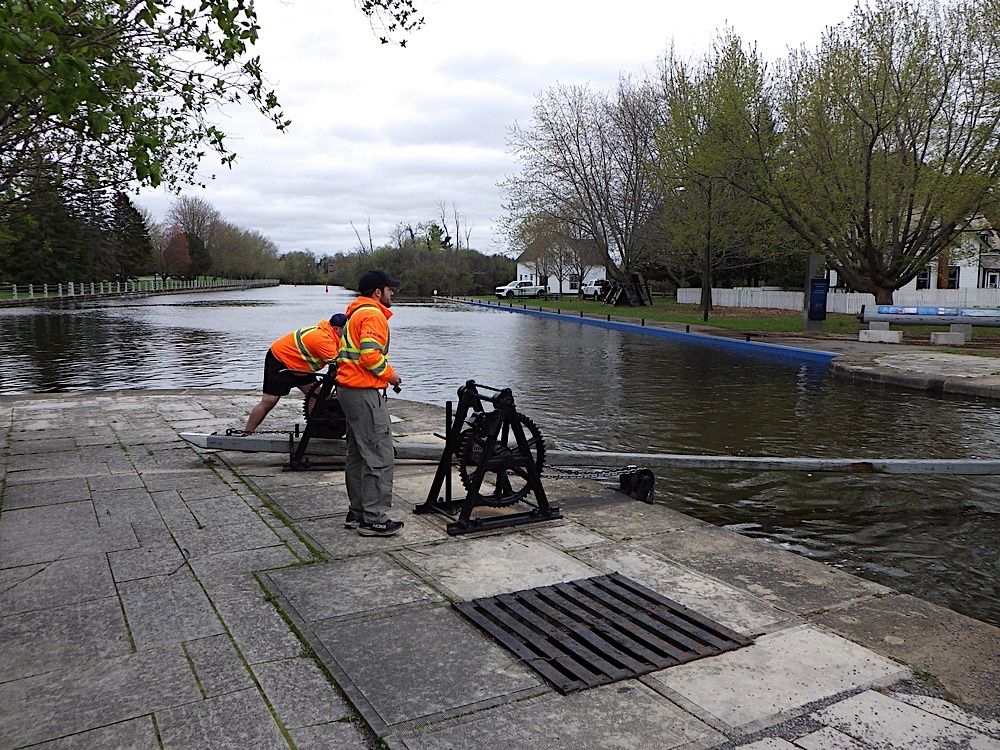 Some Parks Canada canal workers closing the lock gates