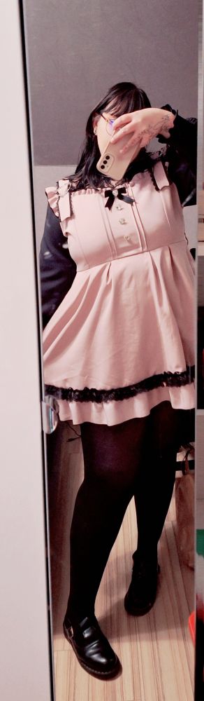 me, tall plus size girlie, wearing a pastel pink frilly dress with black lace