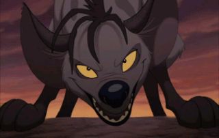 Shenzi from the lion king. She is a grey hyena with yellow eyes, dark spots, and black socks. black, frond-like hair falls from a tuft at her crown, and her snout is short, curling upwards. in the image she towers over the camera on all fours, tilting her head side to side while narrowing her eyes and speaking