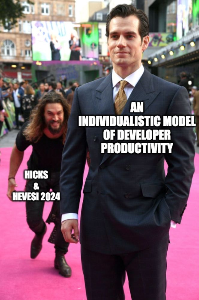 Meme showing Jason Momoa sneaking up behind Henry Cavill on the red carpet. Text reads: An individualistic model of developer productivity, and Hicks & Hevesi 2024, implying that Hicks & Hevesi 2024 will launch a surprise attack on an individual model of developer productivity