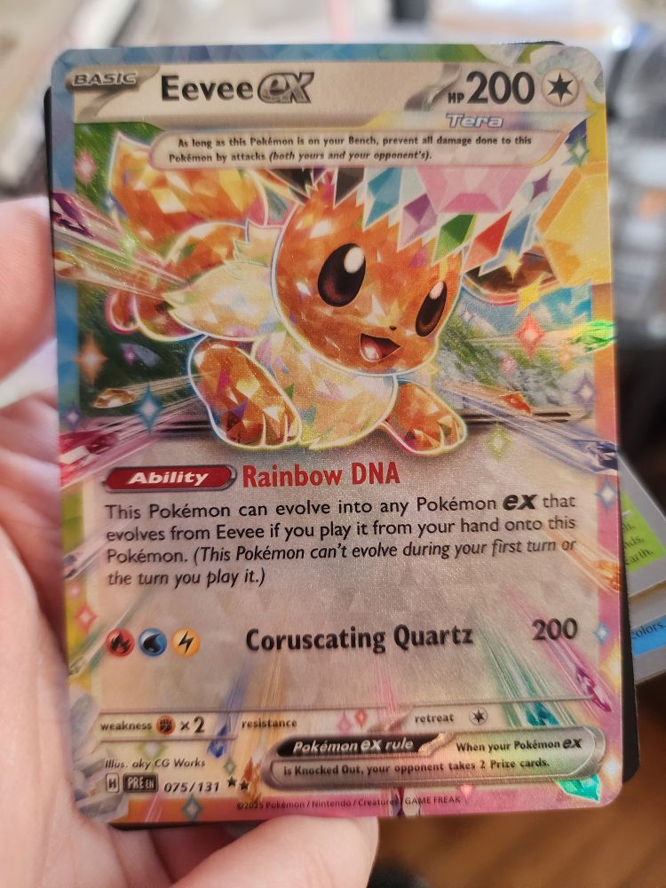 A photo of a prismatic EX Eevee pokemon trading card