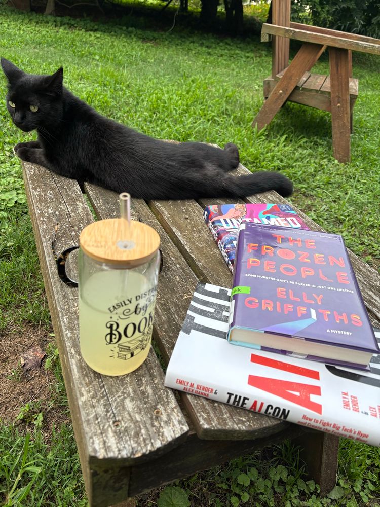 Black cat, beverage, books