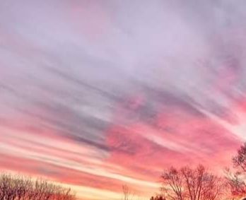 Picture of a sunset; colors yellow to pink to purple racing across the sky.