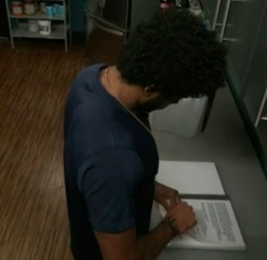 BB23 Kyland consulting the rule book in the storage room