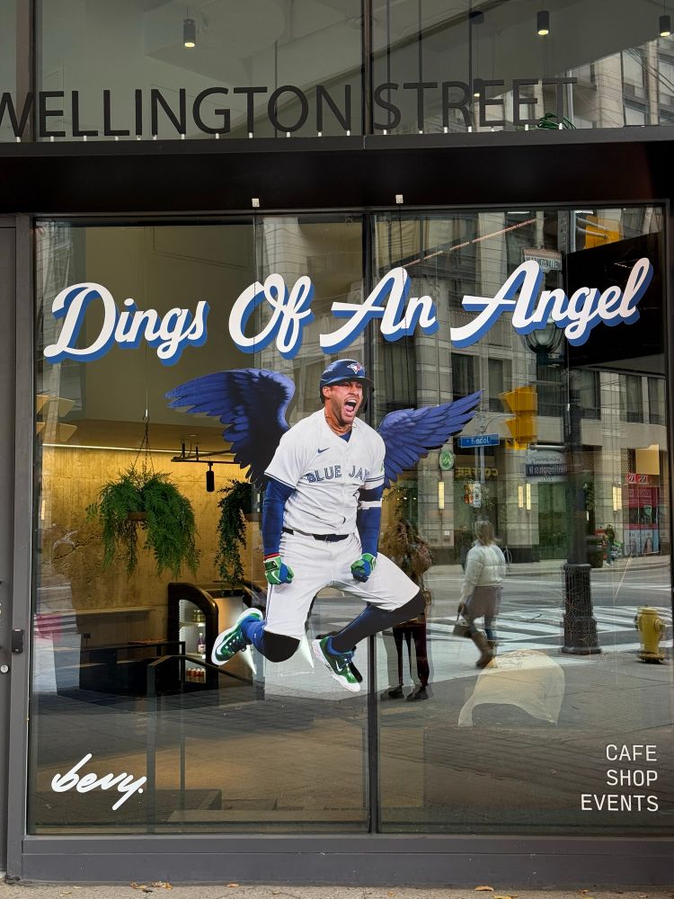 An image of George Springer in Jays uniform jumping into the air with blue wings drawn on and the words Dings of An Angel above him 