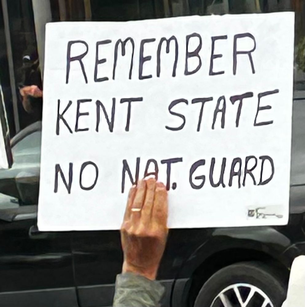 Hand-lettered sign:  REMEMBER KENT STATE. NO NATIONAL GUARD
