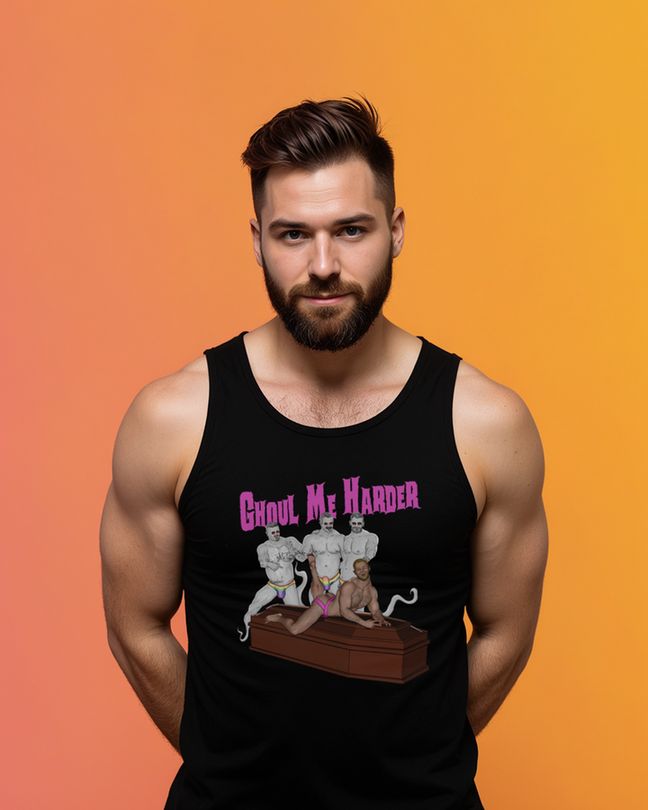 Photo of a man wearing a black hoodie, t-shirt, or tank top featuring a Halloween artwork: a muscular man in pink underwear posing on a coffin, surrounded by ghostly muscle daddies in rainbow jockstraps. Text reads “Ghoul Me Harder.”