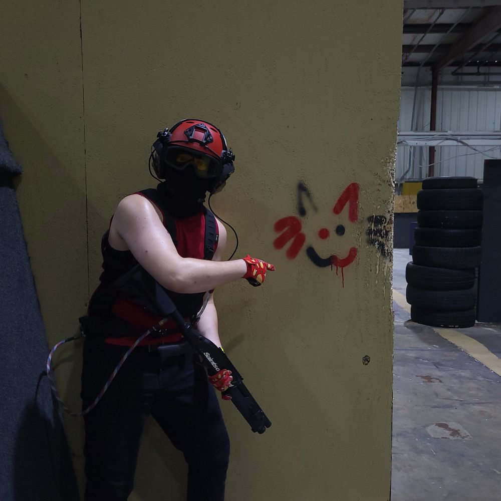 Competitive Indoor Airsoft in Tampa Florida where a silly red guy is pointing at himself i think idk ngl